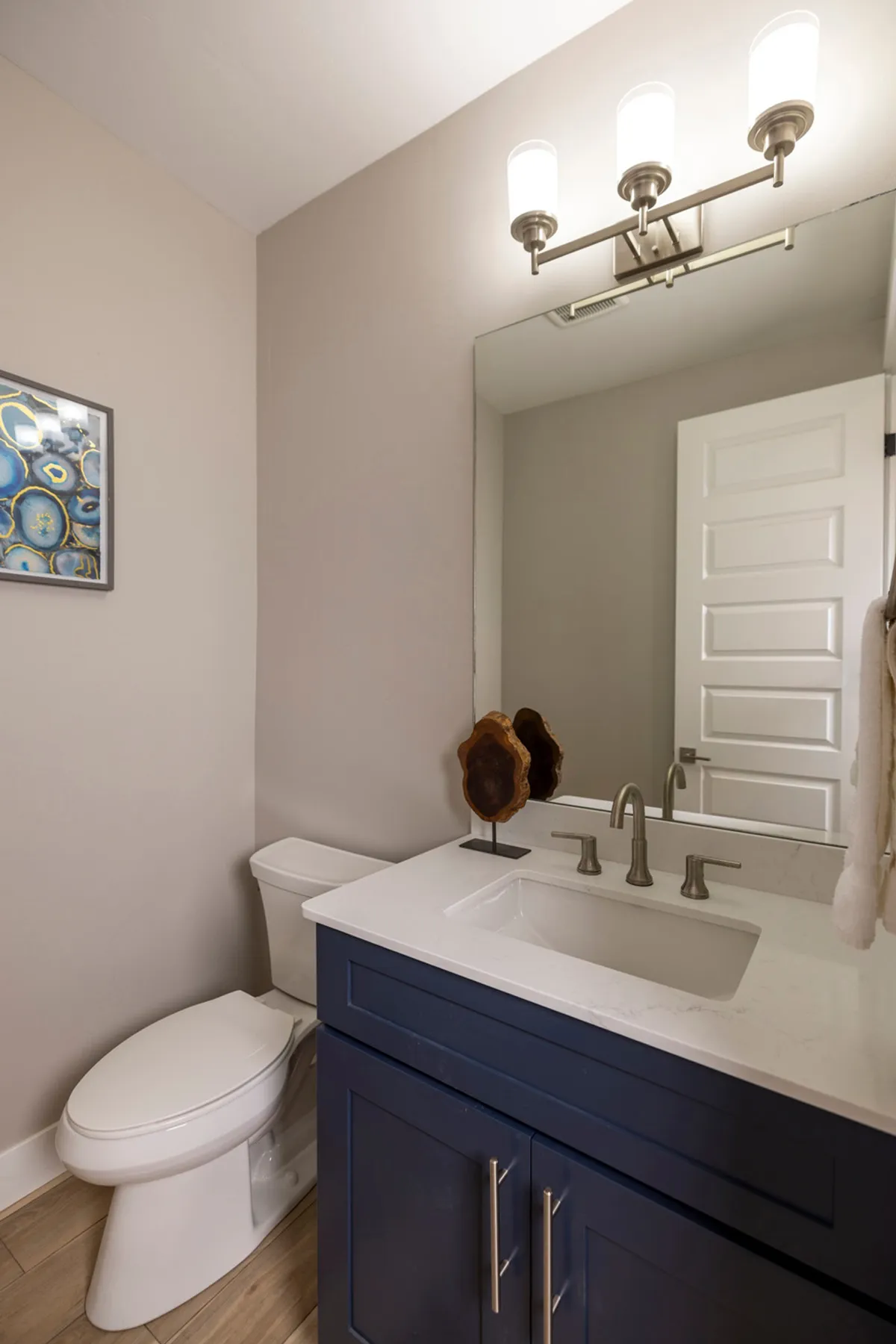 A stylish bathroom with a contemporary vanity, sink, decorative wall art, and modern lighting. The space looks clean, fresh, and functional—ideal for quick freshening up or unwinding after a day on the slopes.